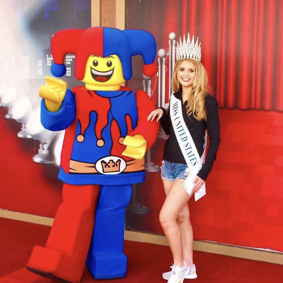 Lily stands with a Lego costumed figure at LEGOLAND