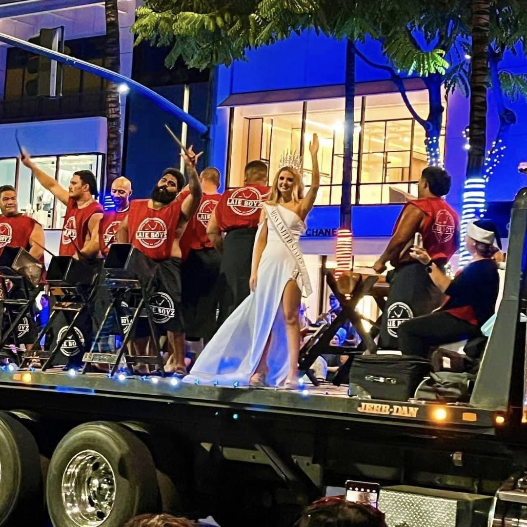 Lily waves from a parade float in Hawaii