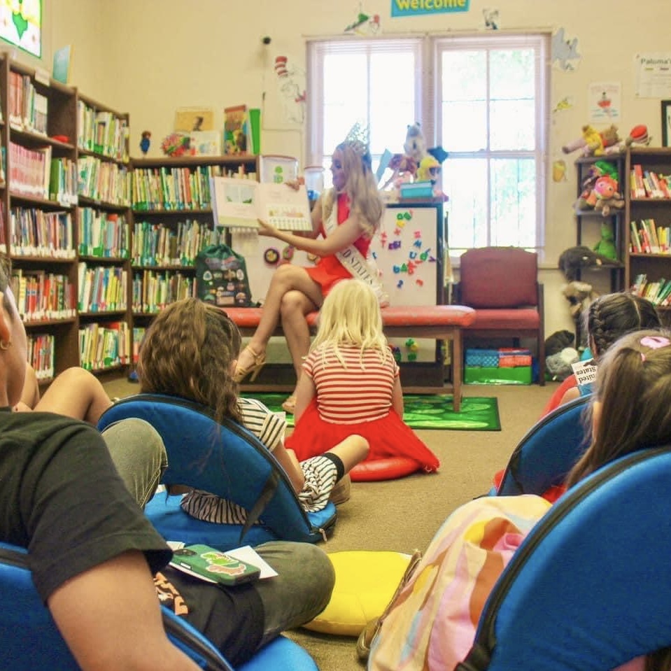 Lily reads to children at a public library