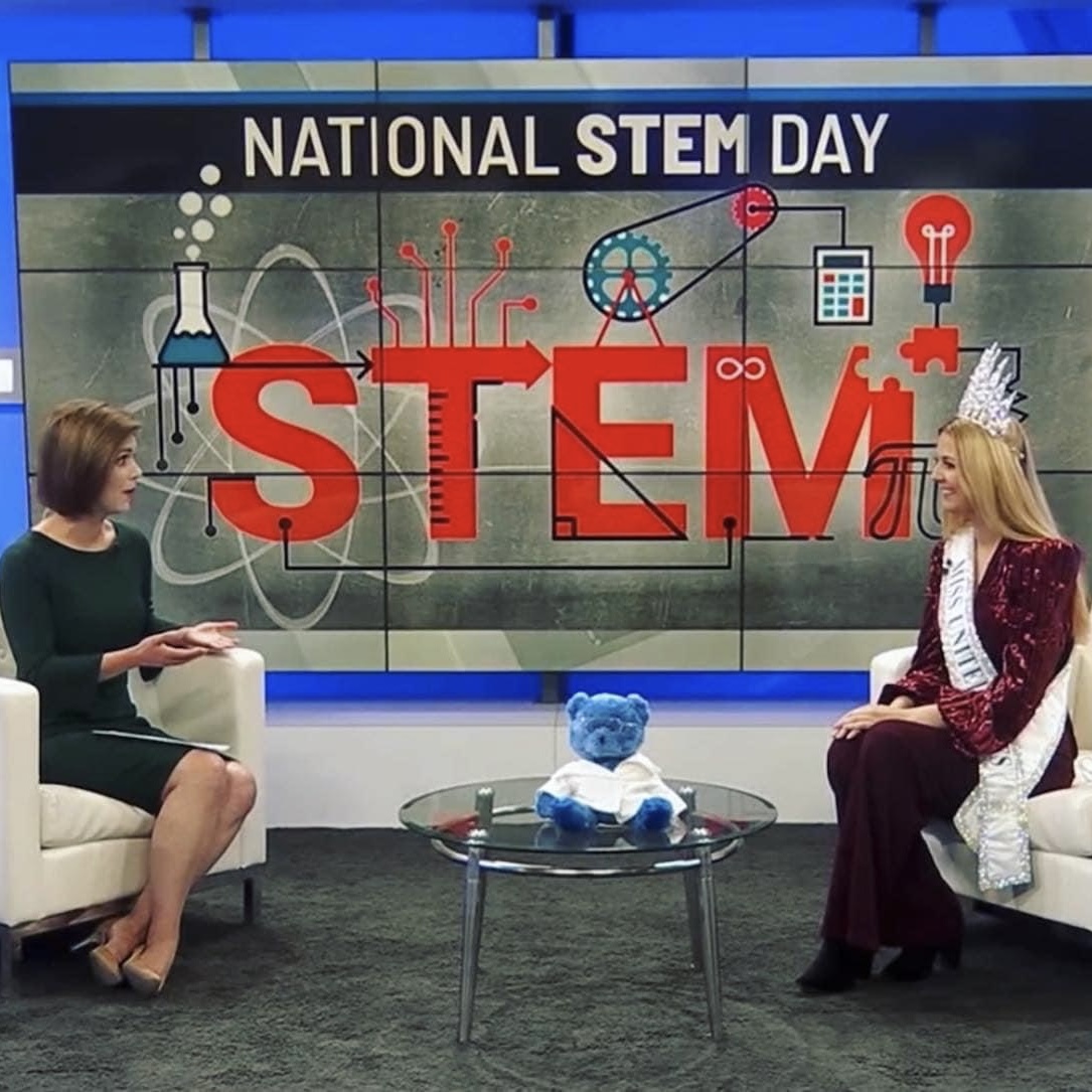 Lily with a news anchor on national STEM day